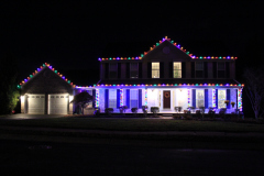 Christmas lights installed along the roofline and entryway, giving this home a polished holiday look.
