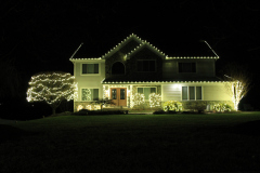 Professional holiday lighting installation with soft white LEDs for a classic Christmas style.