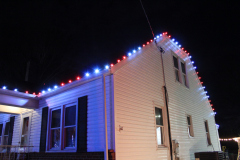 Sykesville Holiday Lighting Candy Cane Roofline adding festive flair. 